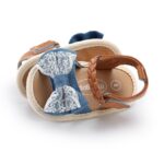 Top view of baby girls denim blue lace bow sandals with braided strap fastening