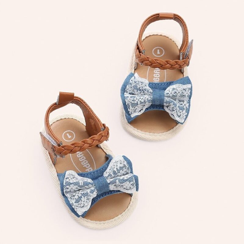 Baby girls denim blue lace bow sandals styled as a pair with braided fastening straps