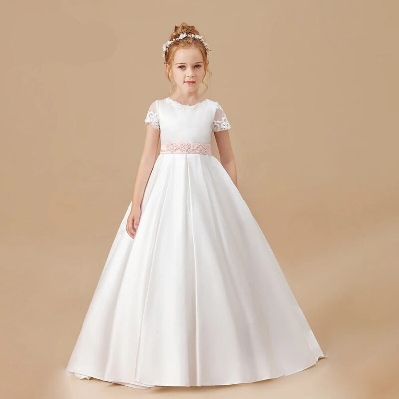 Ivory satin flower girl dress with lace cap sleeves, blush pink embellished waist sash and full length princess style skirt