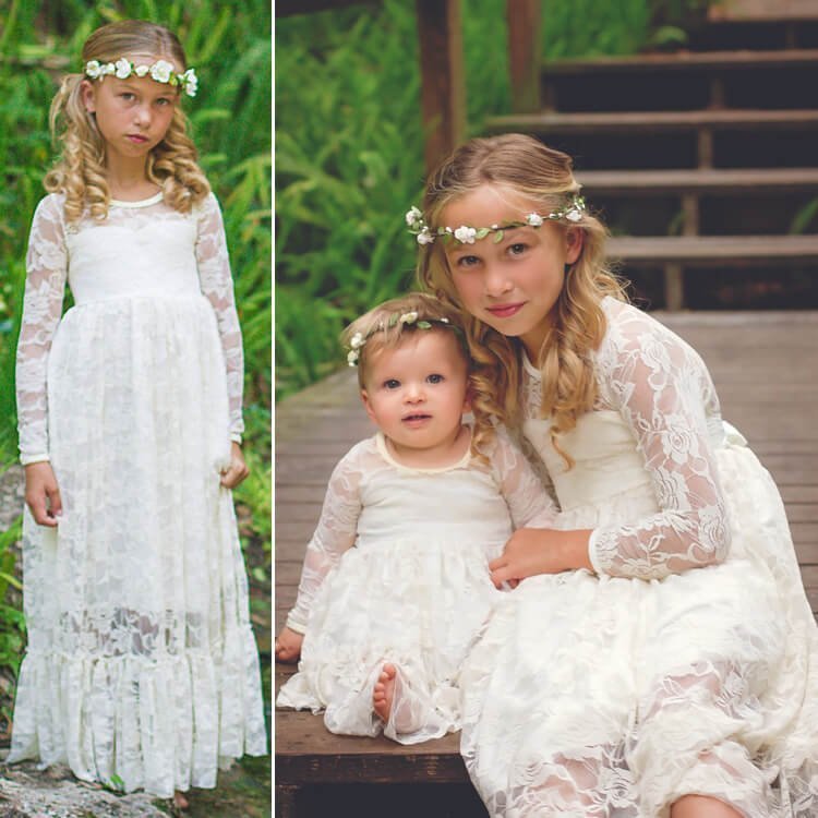 Two girls wearing ivory lace flower girl dresses with long sleeves sitting together with floral headbands