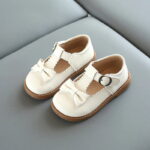 Girls off white faux leather T-bar bow shoes with rounded toe, secure buckle strap and comfortable everyday fit