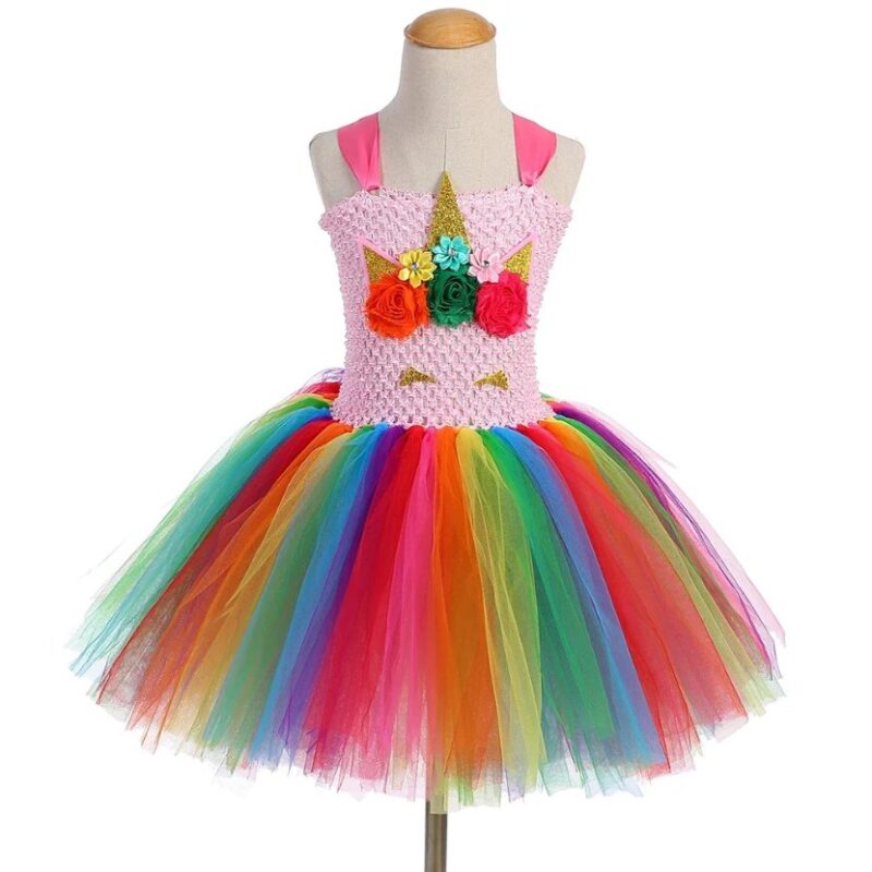 Front view of Golden Rainbow Unicorn Tutu Dress Set featuring a pink crocheted unicorn bodice, colourful rainbow tulle skirt, floral unicorn face design and glitter gold horn