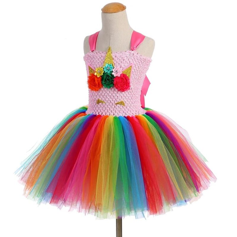 Angled view of Golden Rainbow Unicorn Tutu Dress Set with rainbow layered tulle skirt, pink satin shoulder straps, floral unicorn face embellishment and glitter gold horn