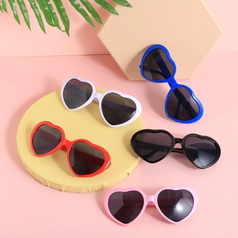 Set of colourful heart shaped diffraction sunglasses in red, pink, white, blue and black, novelty eyewear for festivals and parties
