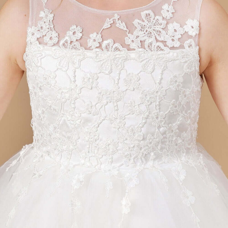 Close up front view of ivory flower girl dress with lace illusion neckline and floral detail