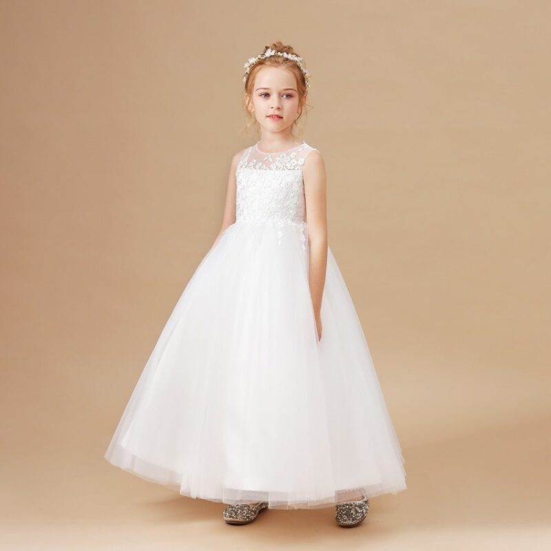 Girl wearing ivory flower girl dress with lace top and elegant tulle skirt for formal events