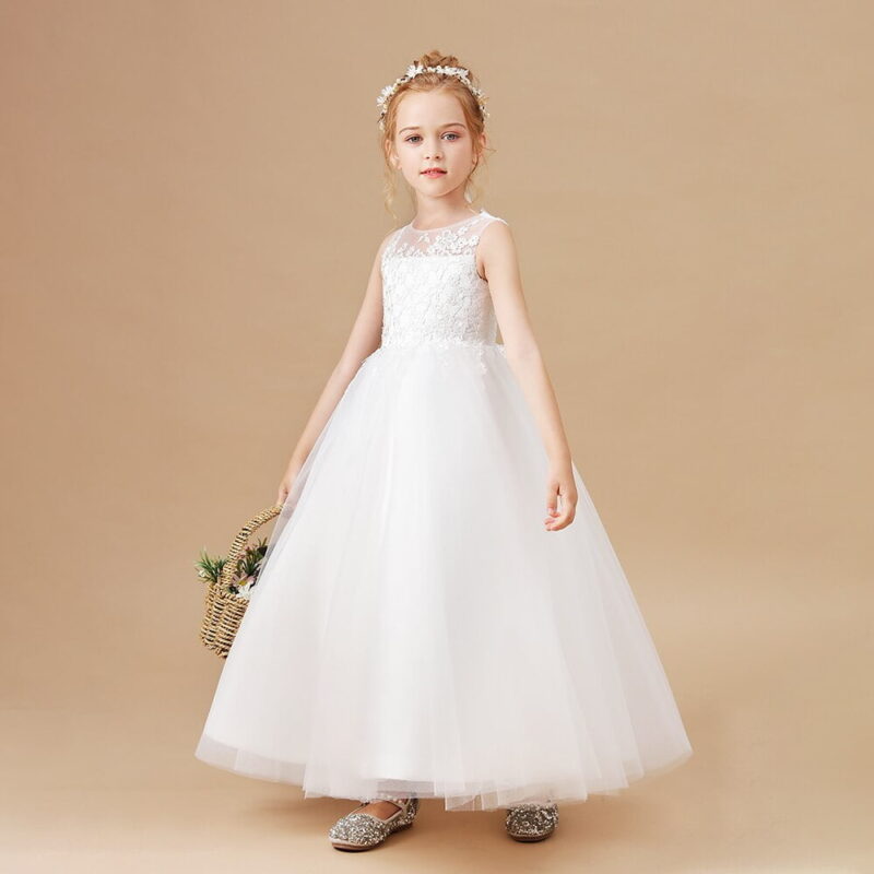 Girl wearing ivory flower girl dress with lace bodice and full tulle skirt for wedding occasion