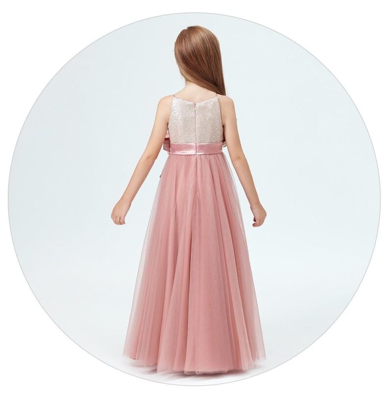 Rear view of dusty pink junior bridesmaid gown with sequin bodice, satin waistband and full length layered tulle skirt.