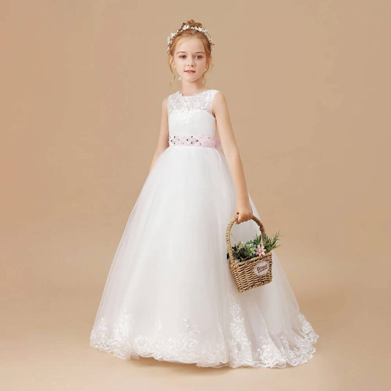 White girls flower girl gown with pink embellished waistband, lace bodice and flowing embroidered tulle skirt for weddings and formal occasions.