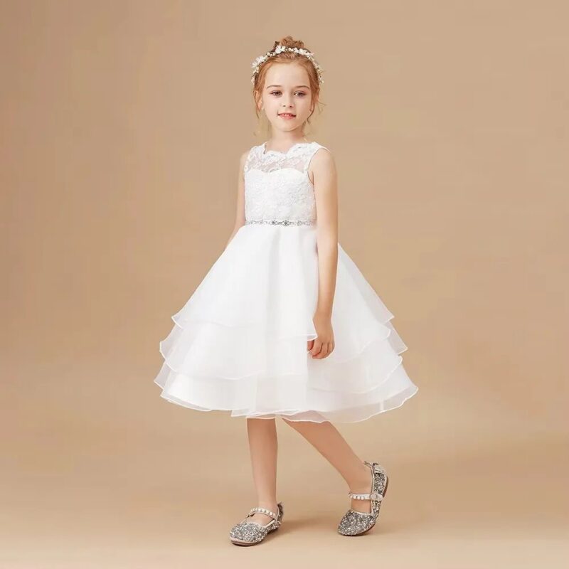 Close up of ivory flower girl dress bodice with lace overlay, floral embroidery and embellished waistband detail