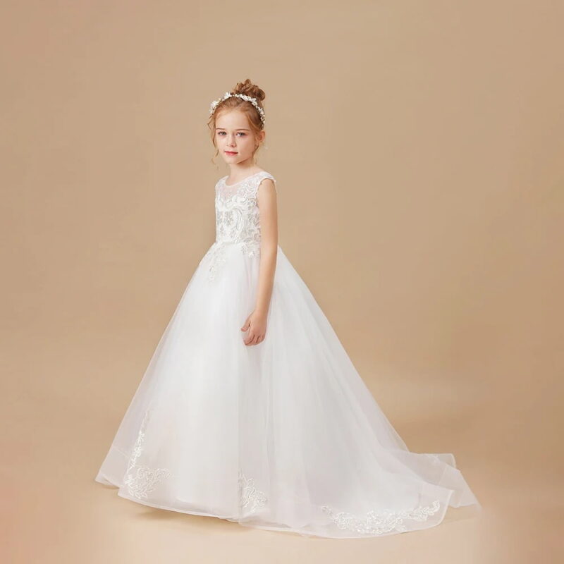 Side view of ivory flower girl ball gown featuring lace appliqué bodice, sweeping train and elegant princess silhouette.