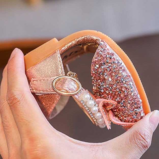 Flexible pink girls sparkly butterfly shoes showing bendable sole, lightweight comfortable kids footwear