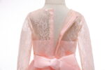 Close up back detail of pink flower girl dress showing lace bodice, zip fastening and satin waistband