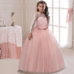 Pink long sleeve lace flower girl dress with tulle ball gown skirt and fitted waist detail