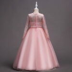 Back view of pink flower girl dress with lace bodice, long sleeves and voluminous tulle skirt