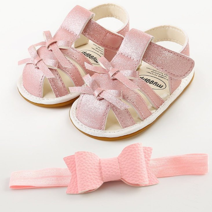 Pink shimmer baby girl gladiator sandals with bow detail and matching headband set for infants