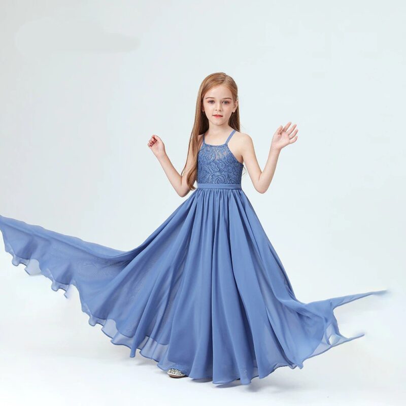 Young girl twirling in slate blue chiffon junior bridesmaid dress with flowing skirt