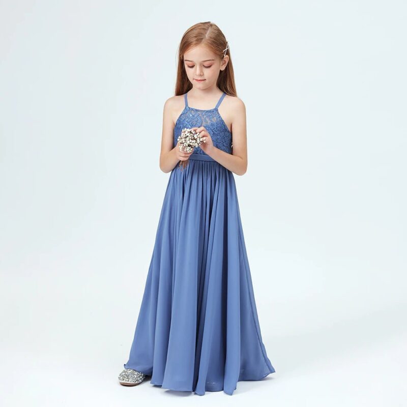 Young girl standing in slate blue junior bridesmaid dress holding small bouquet