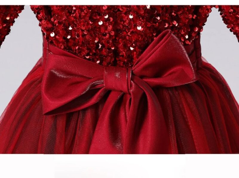 Close up of the satin waist bow on the girls burgundy red sequin flower girl dress