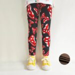 Black bow print winter leggings for girls with red and white bow pattern and warm brown fleece lining