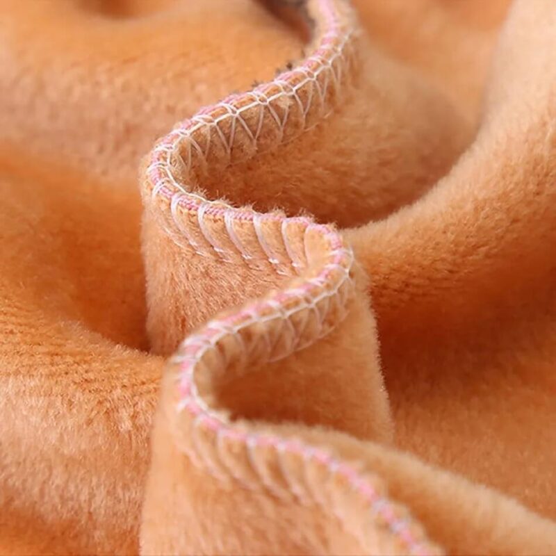 Close-up of soft plush fleece lining and stitched seams inside girls embroidered bunny winter leggings