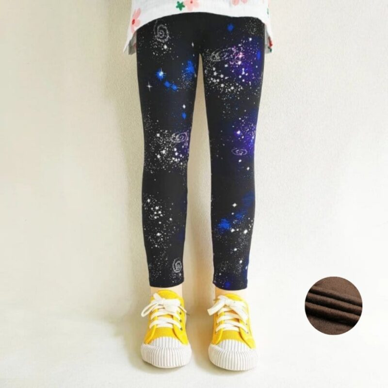 Girl wearing black galaxy print winter leggings with blue, purple and white stars and warm fleece lining.