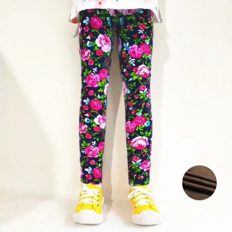 Girl wearing navy blue rose print winter leggings with pink flowers, green leaves and warm fleece lining.