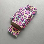 Folded colourful leopard print fleece leggings for girls showing the pink and purple animal print and warm fleece lining.