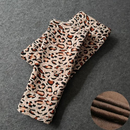 Folded cream leopard print fleece leggings for girls with brown and black spots, showing the soft fleece lining.