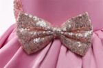 Detailed view of sparkling sequin bow on pink multi-layer princess party dress for girls