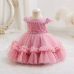 Dark pink princess occasion dress for girls with pearl embellished bodice, puff sleeves and ruffled layered tulle skirt