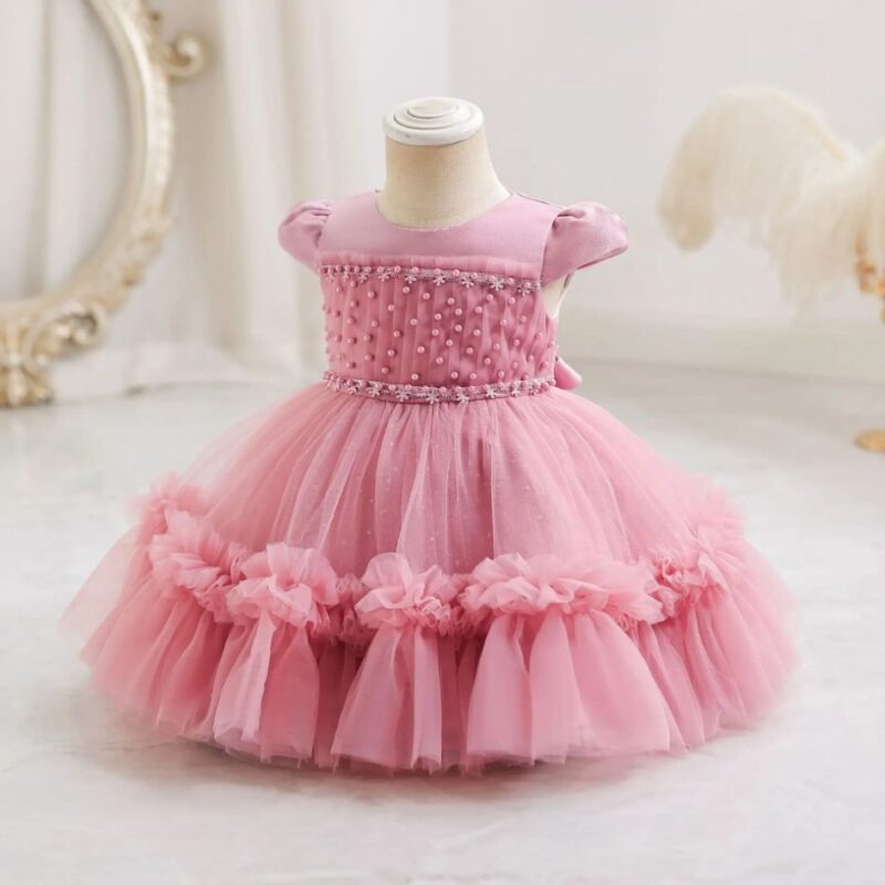Dark pink princess occasion dress for girls with pearl embellished bodice, puff sleeves and ruffled layered tulle skirt