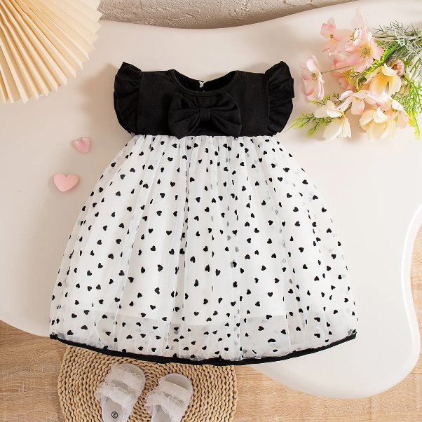Black and white heart print summer dress for toddler girls with flutter sleeves, black bow and layered tulle skirt
