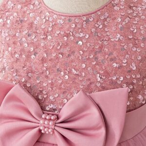 Close-up of pink sequin bodice and large satin bow with pearl detail on girls princess ball gown