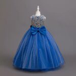 Back view of royal blue girls ball gown with gold sequin floral bodice, large satin bow and sparkling tulle skirt