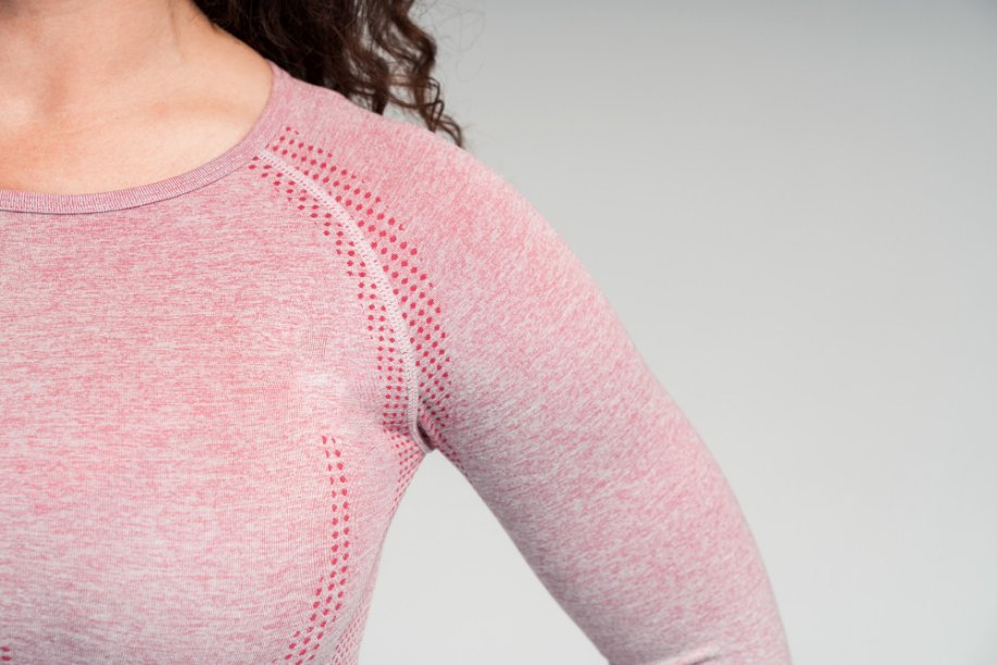 Cotton-Spandex Blend: The Ideal Fabric for Comfortable Performance Wear - Fabulous Bargains Galore Cropped view of the shoulder of curly woman wearing pink sport clothes made of cotton and spandex blend