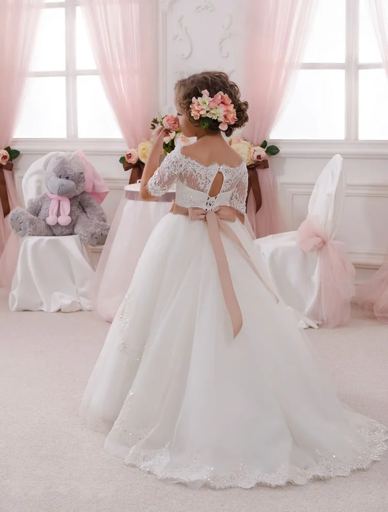 Back view of ivory off shoulder lace flower girl dress with satin bow and elegant tulle train