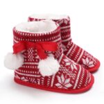 Baby Fair Isle Pom Pom Christmas booties with red and white knitted snowflake pattern, faux fur lining and fluffy pom poms