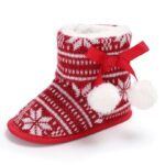 Single Baby Fair Isle Pom Pom Christmas bootie with knitted snowflake pattern, ribbon bow and fluffy pom poms