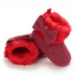 Baby knitted Christmas boots with fluffy fleece lining and decorative bow
