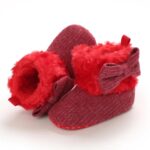 Pair of baby ribbed knit boots with faux fur cuff and soft winter lining