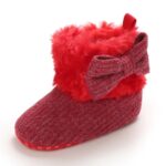 Single baby ribbed knit Christmas boot with fluffy faux fur cuff and bow detail
