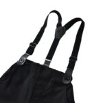 Close up of adjustable black suspenders on boys black formal trousers