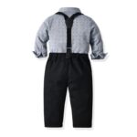 Rear view of boys grey shirt and black suspenders outfit with black trousers