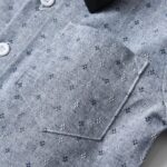 Close up of patterned grey boys formal shirt with stitched chest pocket
