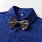 Close up of grey paisley bow tie on boys royal blue formal shirt