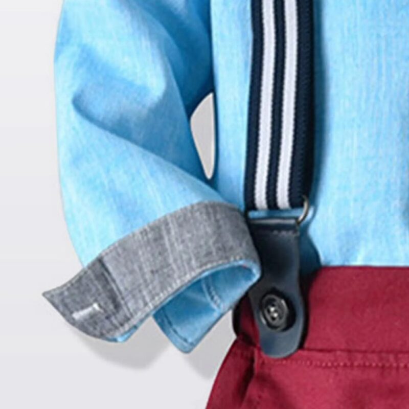 Close up of boys sky blue shirt cuff with striped suspenders