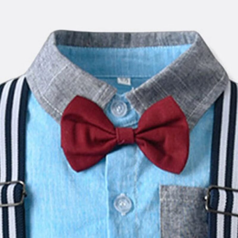 Close up of burgundy bow tie on boys sky blue formal shirt