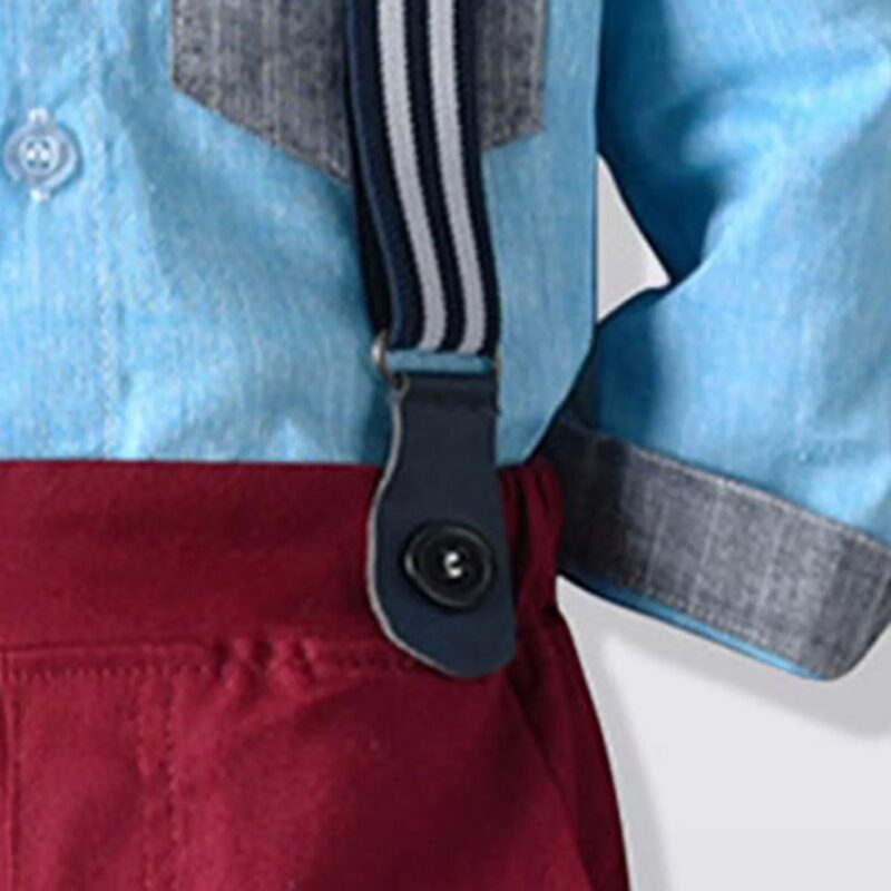 Close up of striped suspenders attached to burgundy boys formal trousers