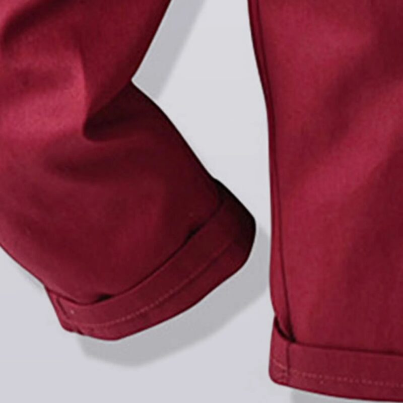 Close up of burgundy boys formal trousers with turned up hem